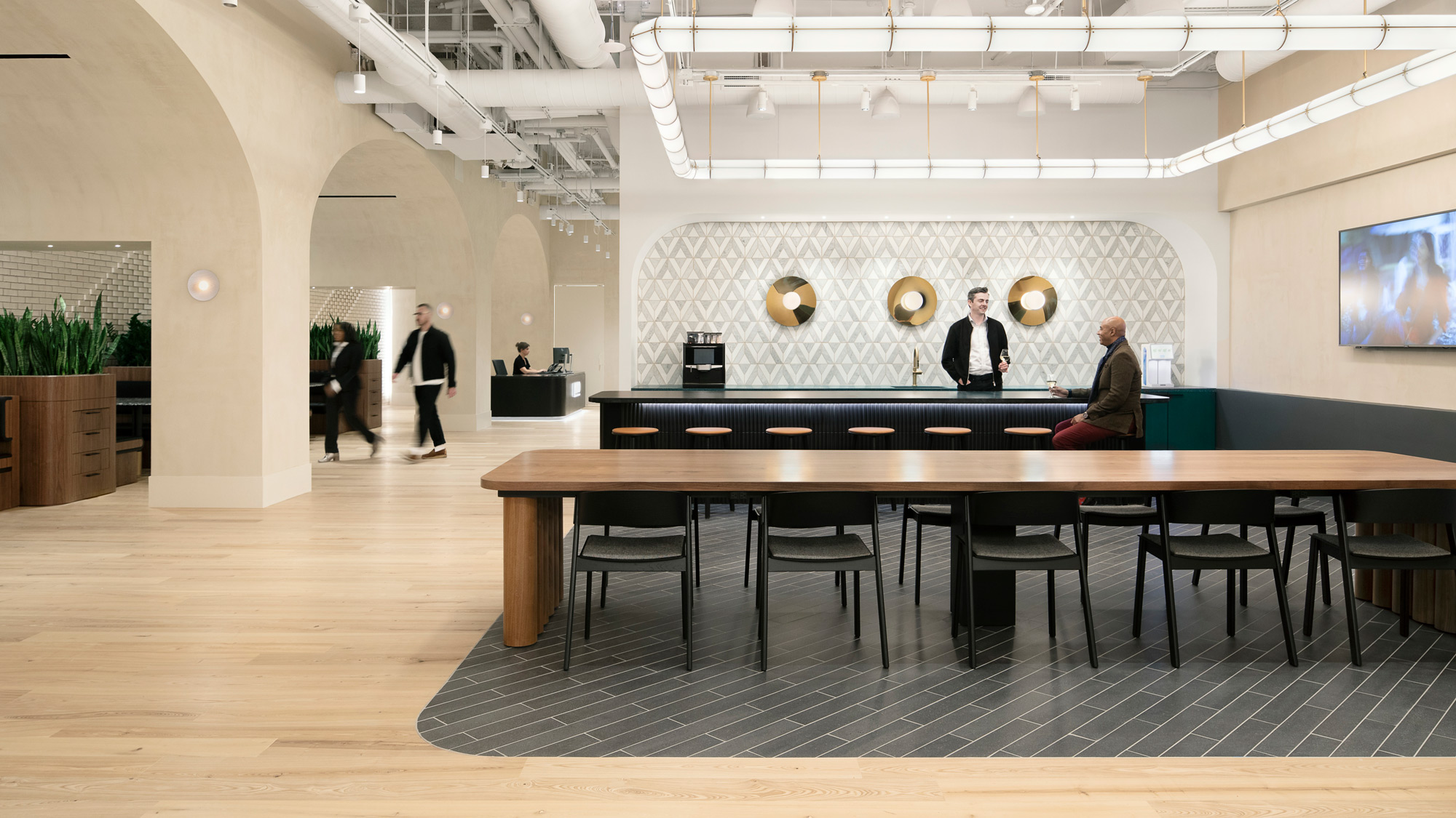 A group of people sitting at a table in a large room.