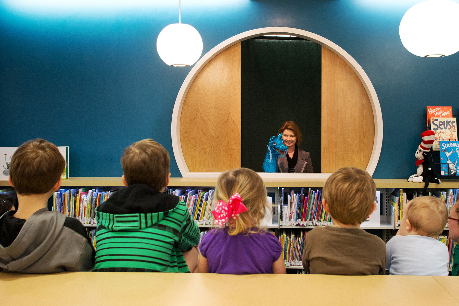 A person speaking to a group of children.