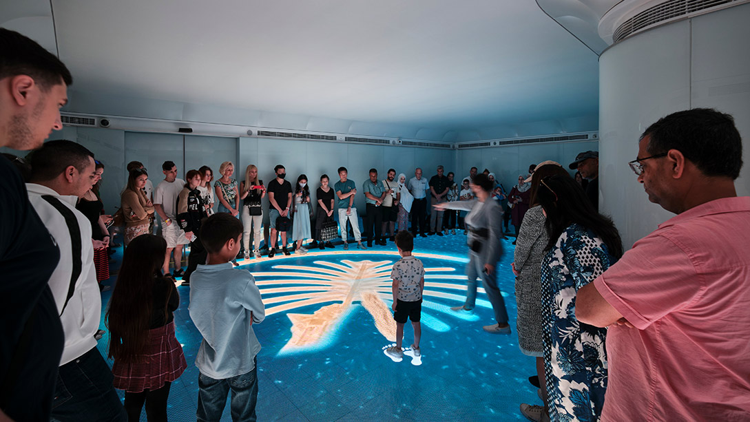 A group of people standing around a pool.