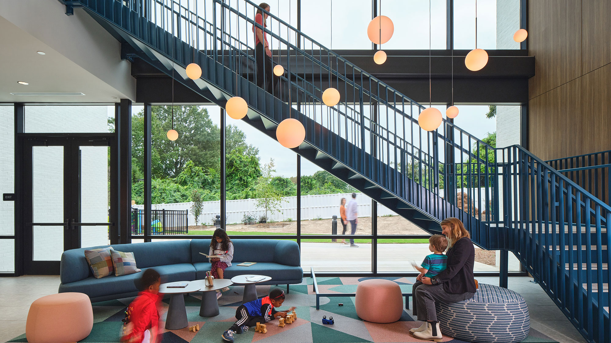 A group of people sitting on a deck with a table and chairs.