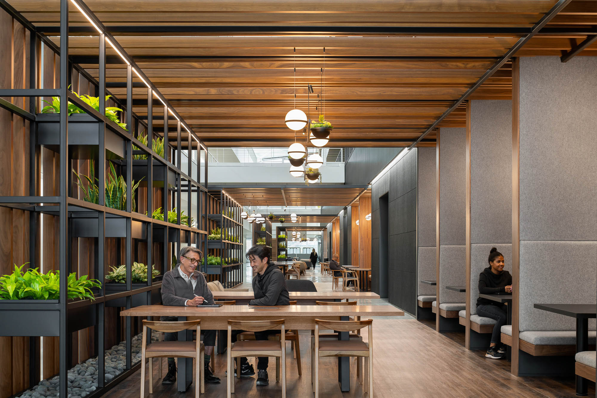 A group of people sitting at a table in a building.