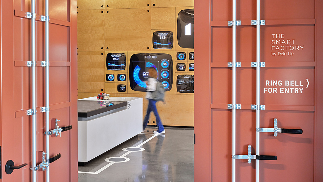 A person standing in a room with lockers.