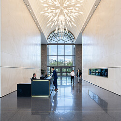 A group of people in a large room with a large glass ceiling.