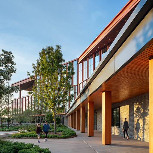 A building with a few people walking.