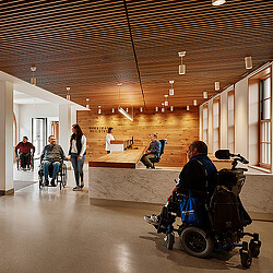 People in a room with a table and chairs.