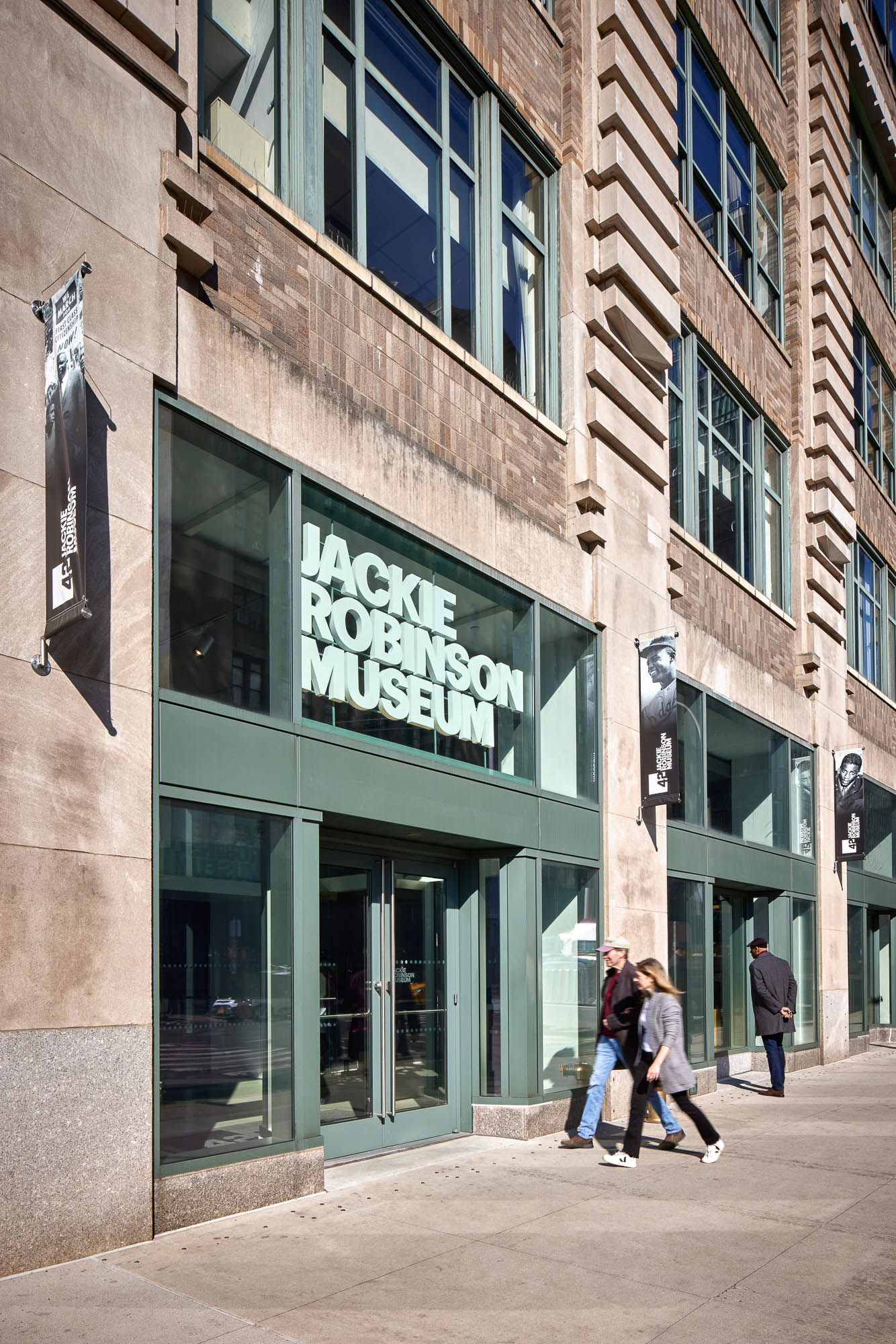 People walking past a building.