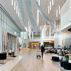 A room with a glass ceiling and a couple of people sitting at tables.