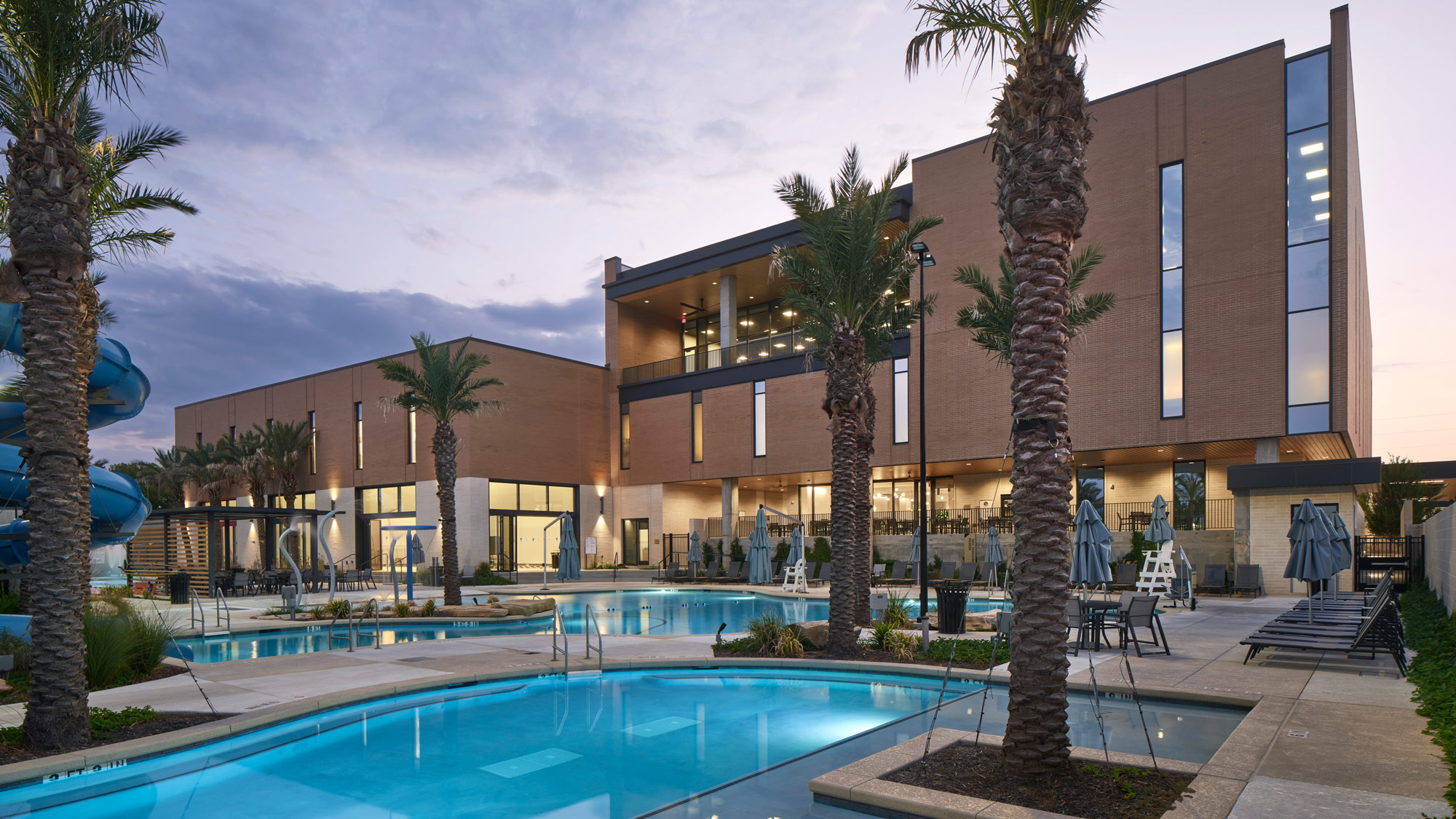 A swimming pool in front of a building.