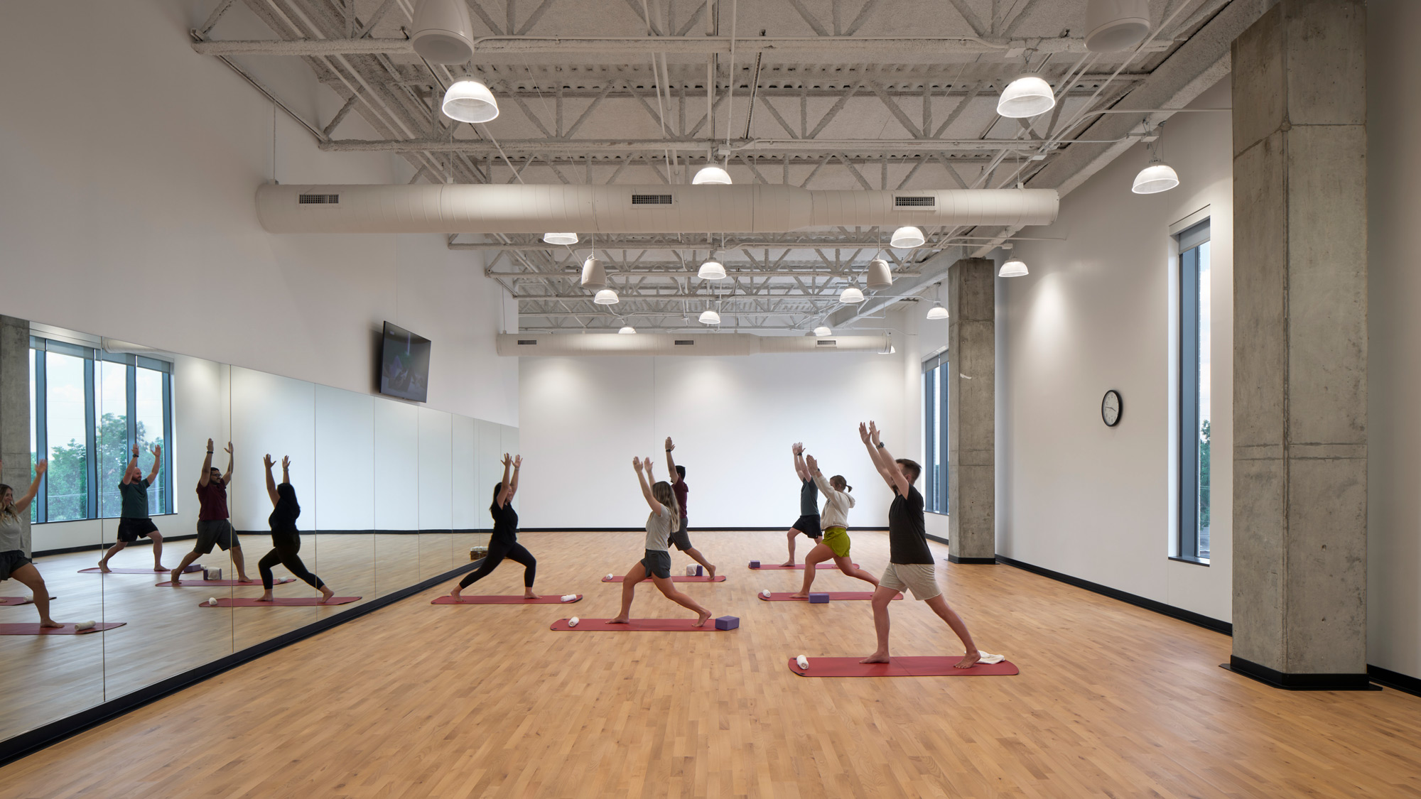 A group of people exercising in a room.