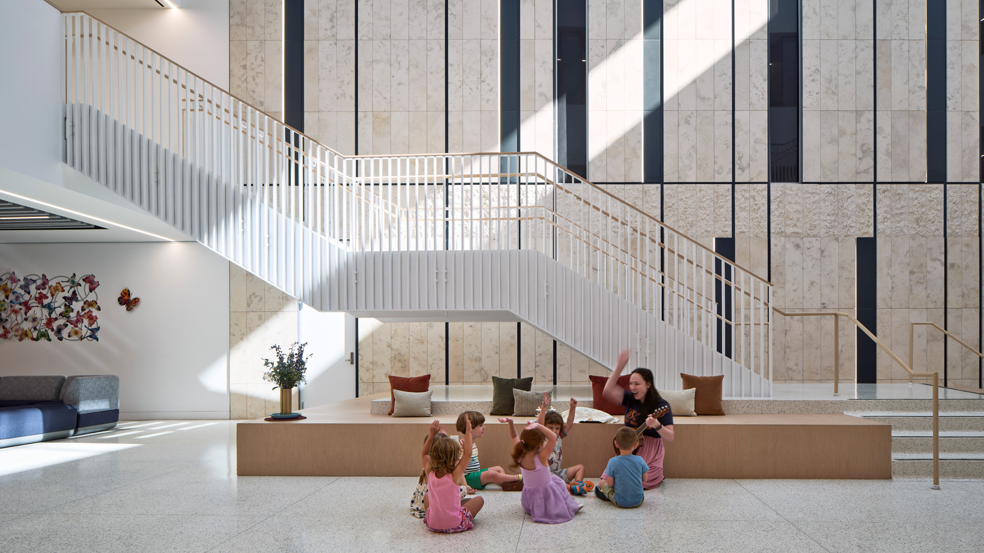 A group of children sitting on the steps of a building.