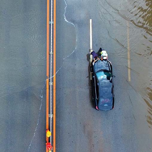 A person riding a blue car.