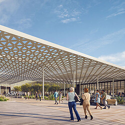 A group of people walking under a glass roof.