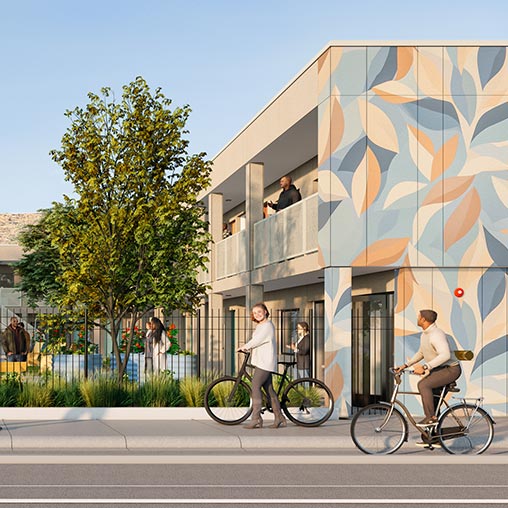 A group of people walking on the sidewalk next to a building.