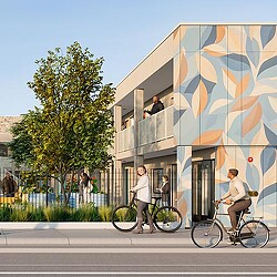 A group of people walking on the sidewalk next to a building.