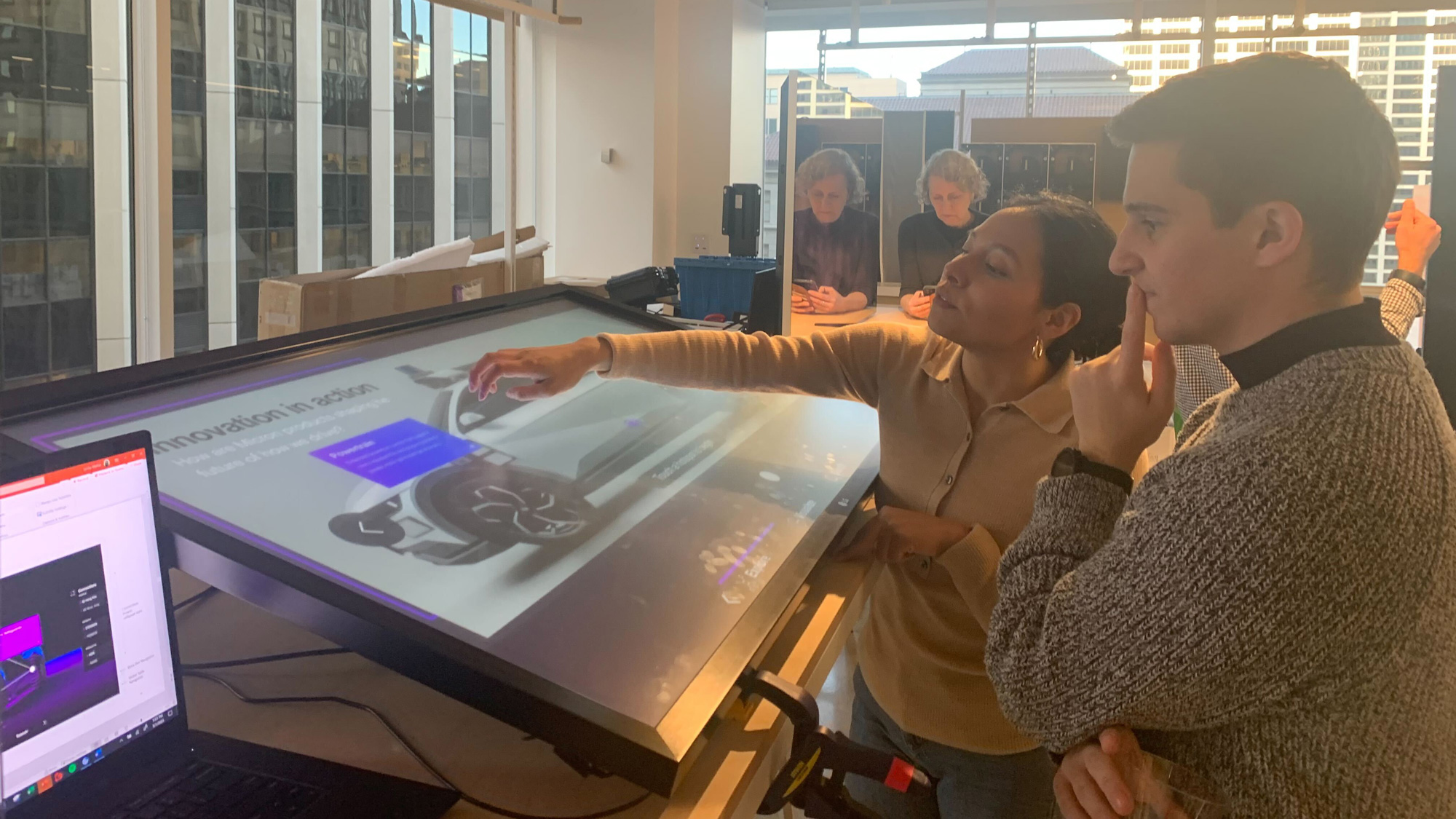 A group of people looking at a computer screen.