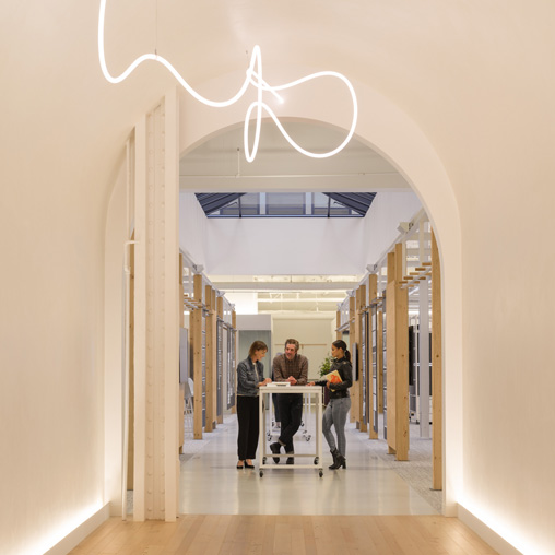 A group of people standing in a hallway.