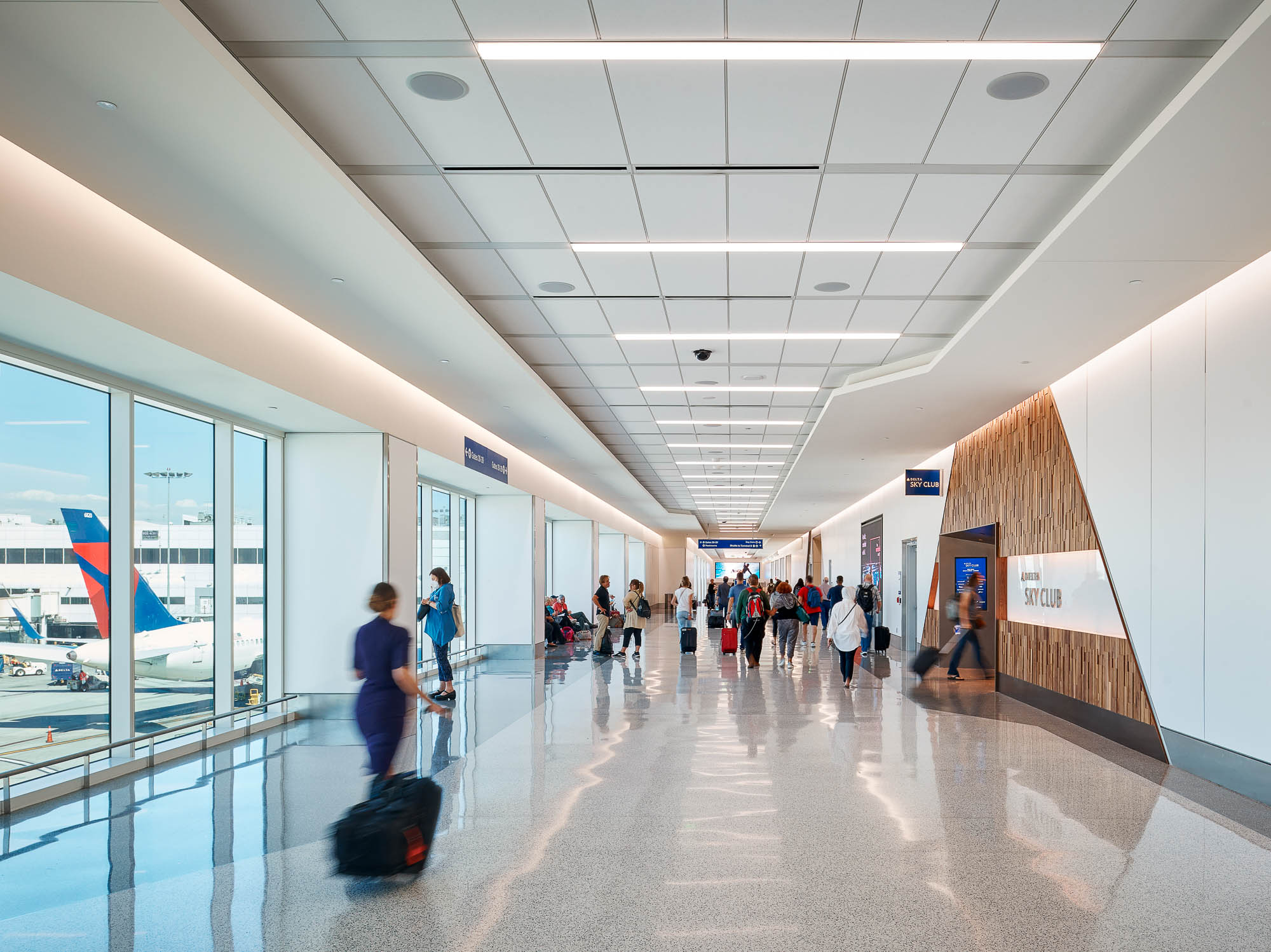 Travelers walking down Delta Sky Way walkway at LAX