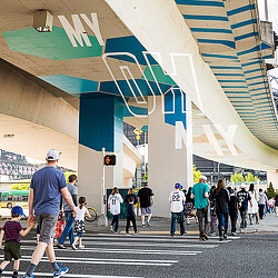 Seattle Mariners fan walking under branded highway underpass