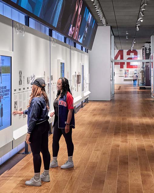 A couple of women looking at a display of a movie.
