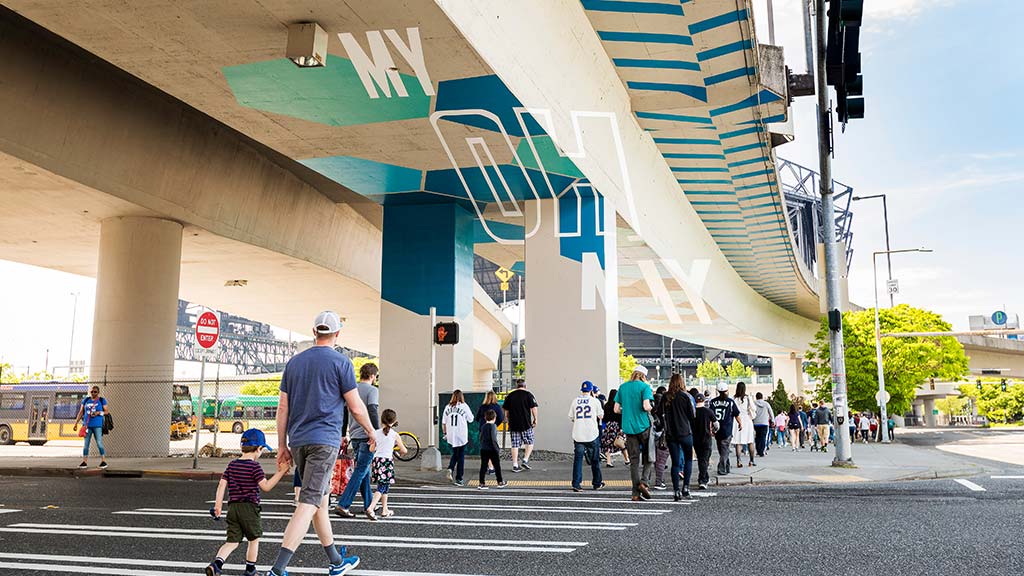 Fans walking under branded Seattle Mariners highway underpass