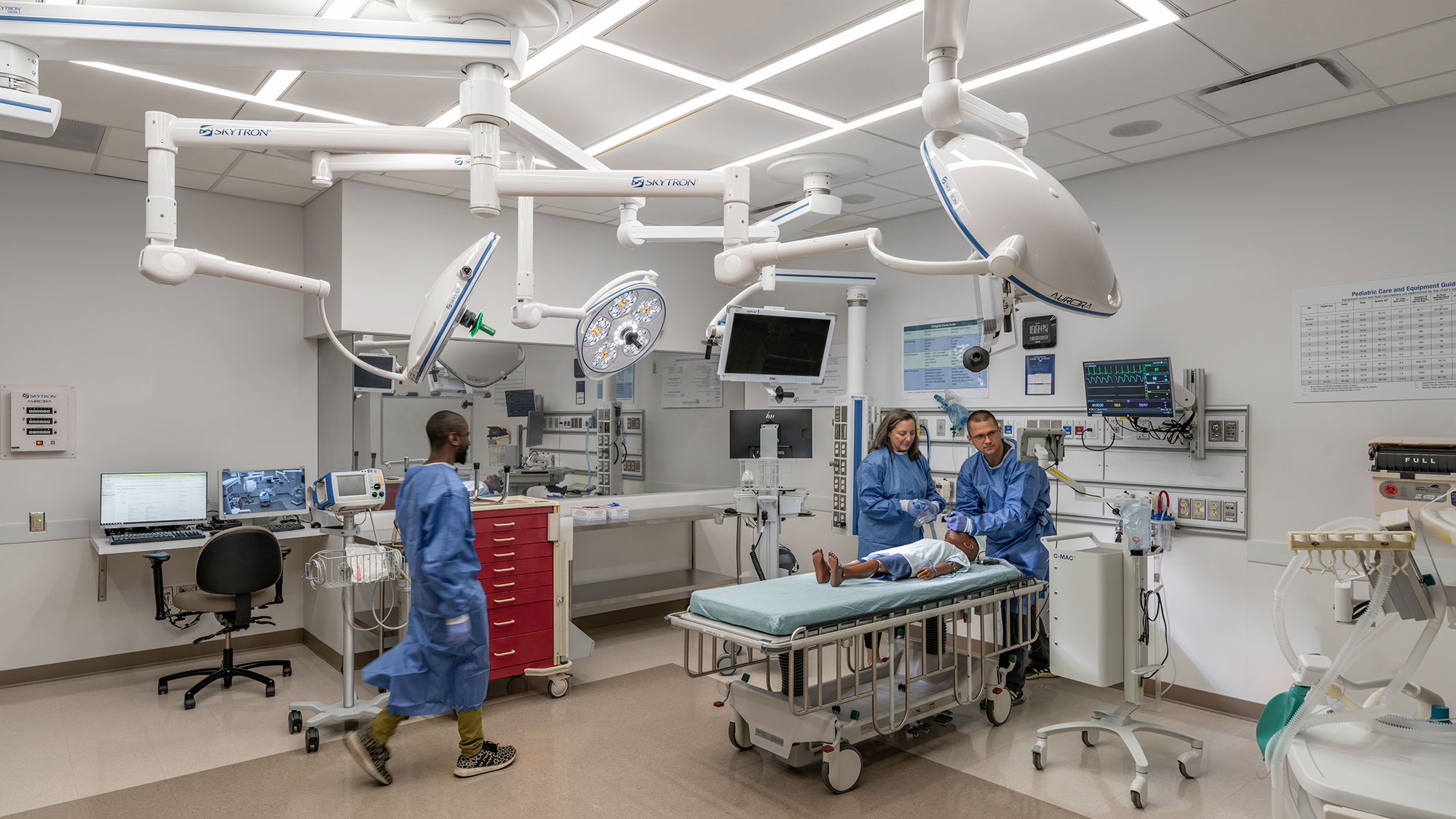 A group of people in a hospital room.