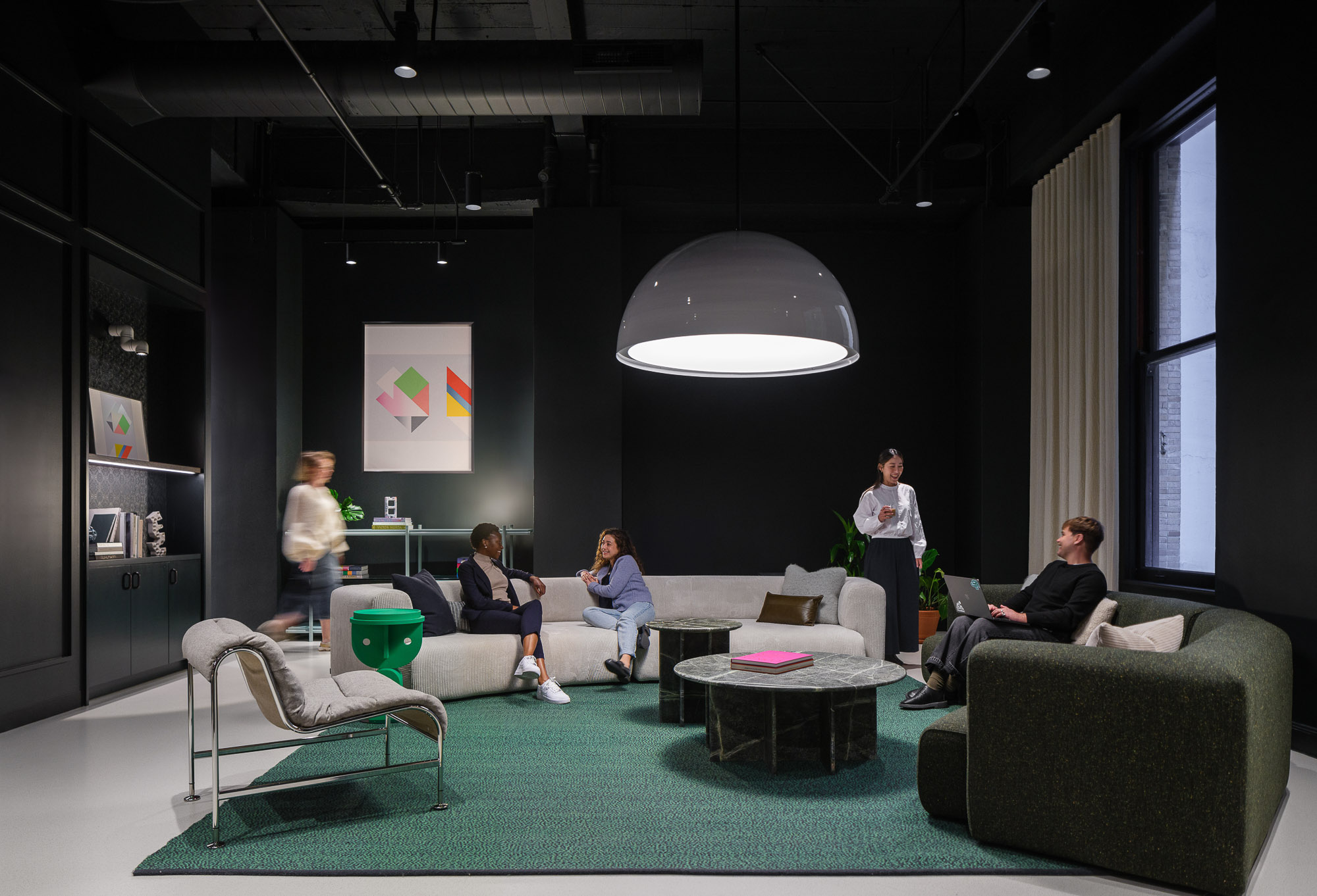 A group of people sitting in a room with a projector screen.