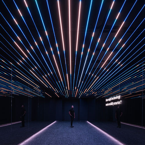 A person standing in a large room with bright lights.