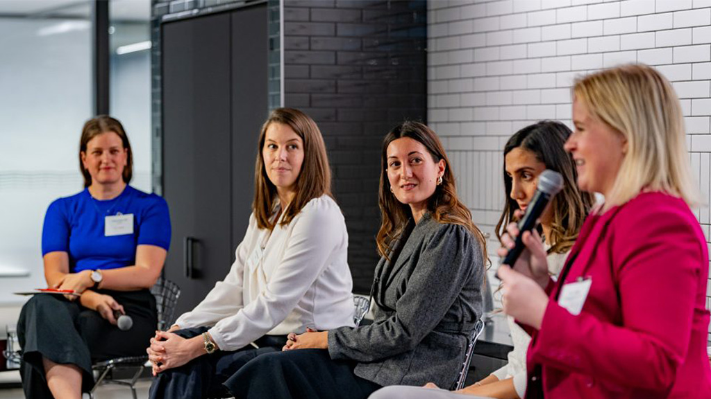 A group of women sitting and talking.