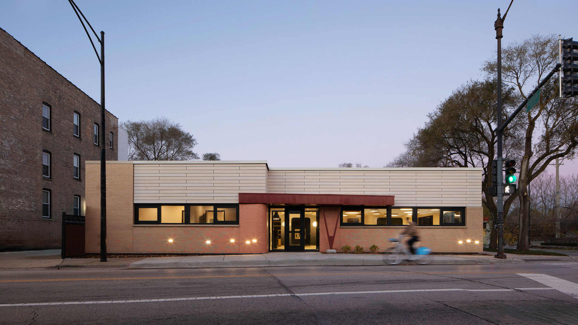 A building with a person riding a bicycle.