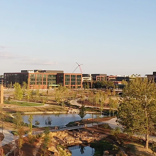 A building with a pond in front of it.