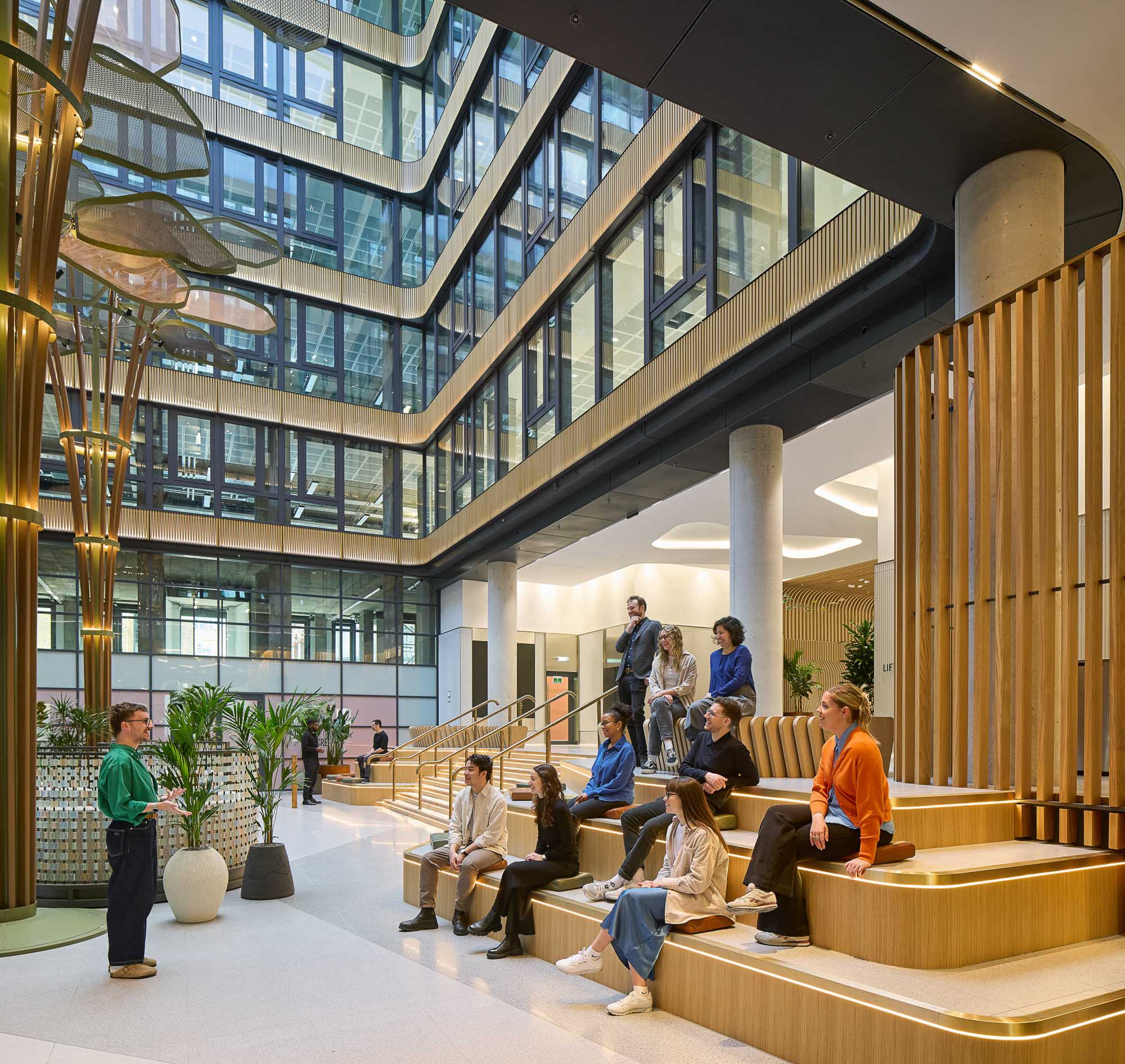 The Acre building interior with people sitting on steps