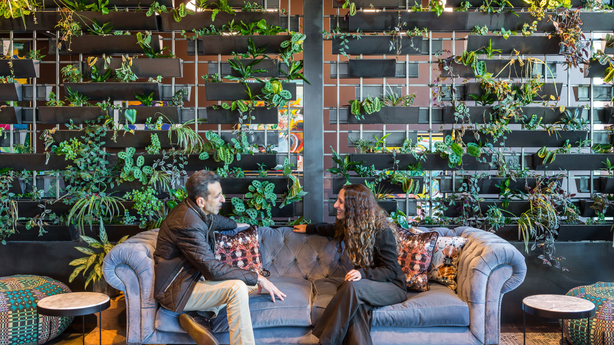 A man and woman sitting on a couch.