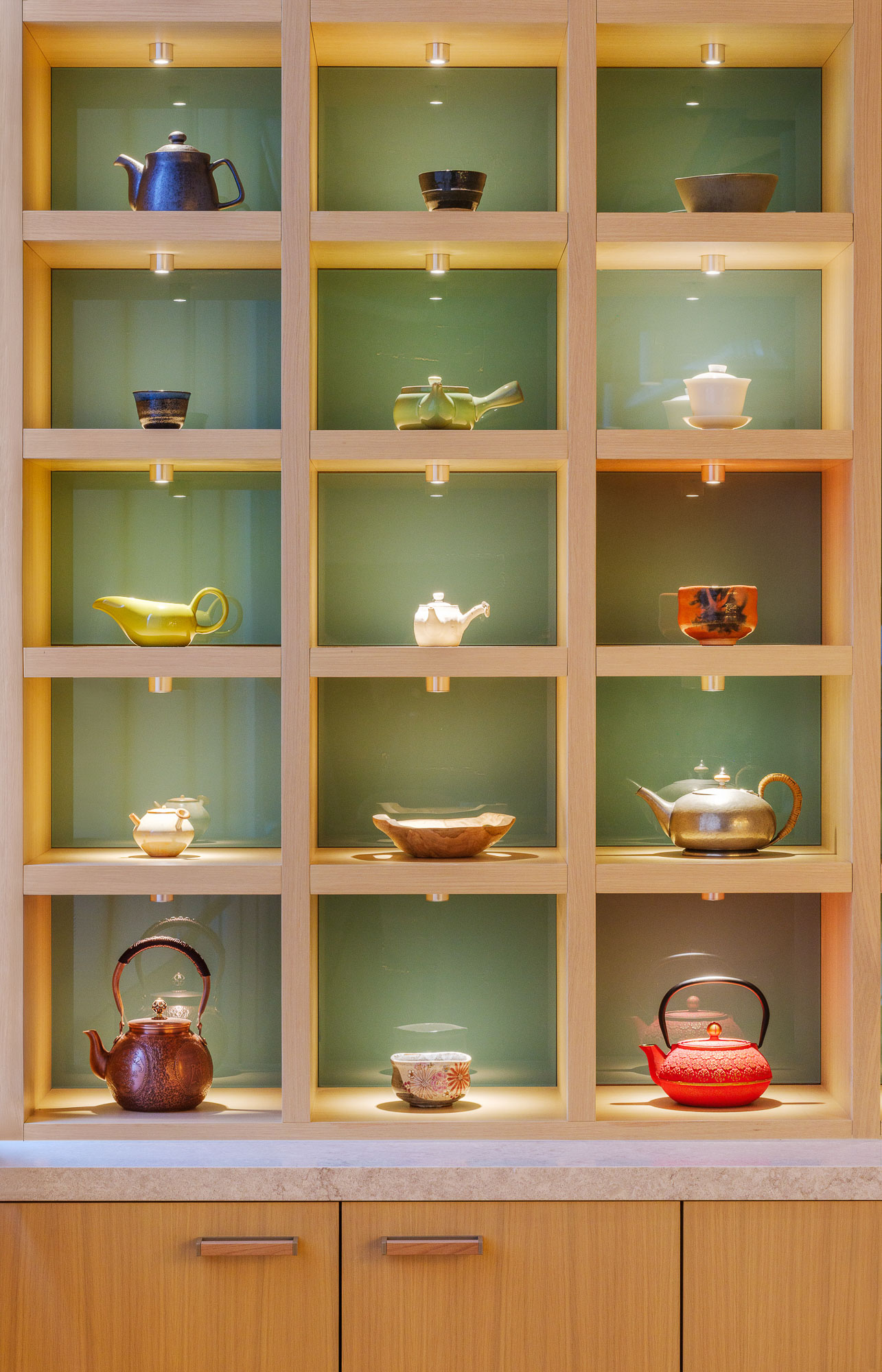 A glass cabinet with teapots and teapots.