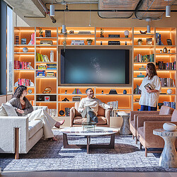 Workplace lounge with couches and a wall filled with decor