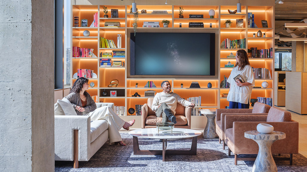 Workplace lounge with couches and a wall filled with decor