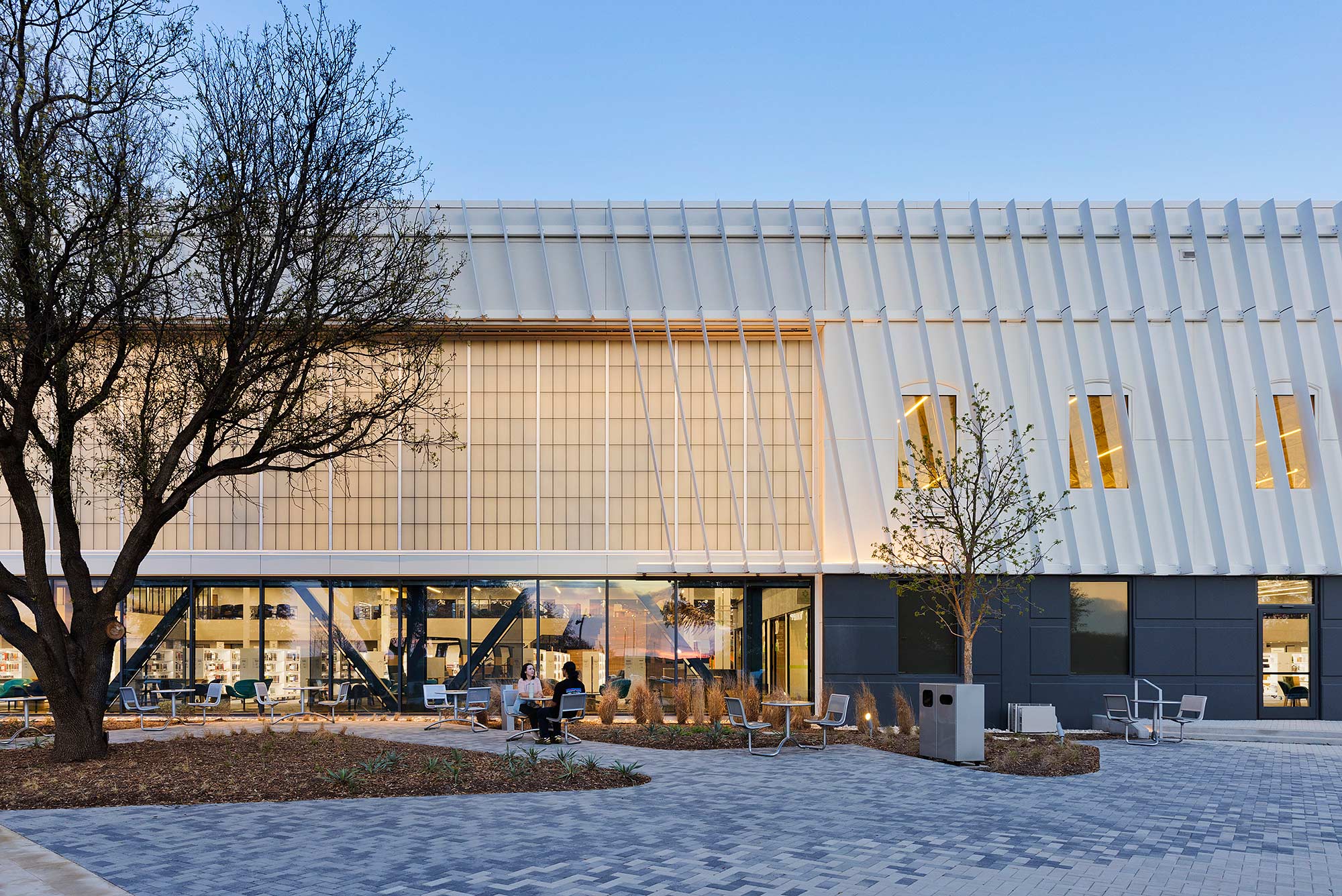 A building with a few people sitting outside.