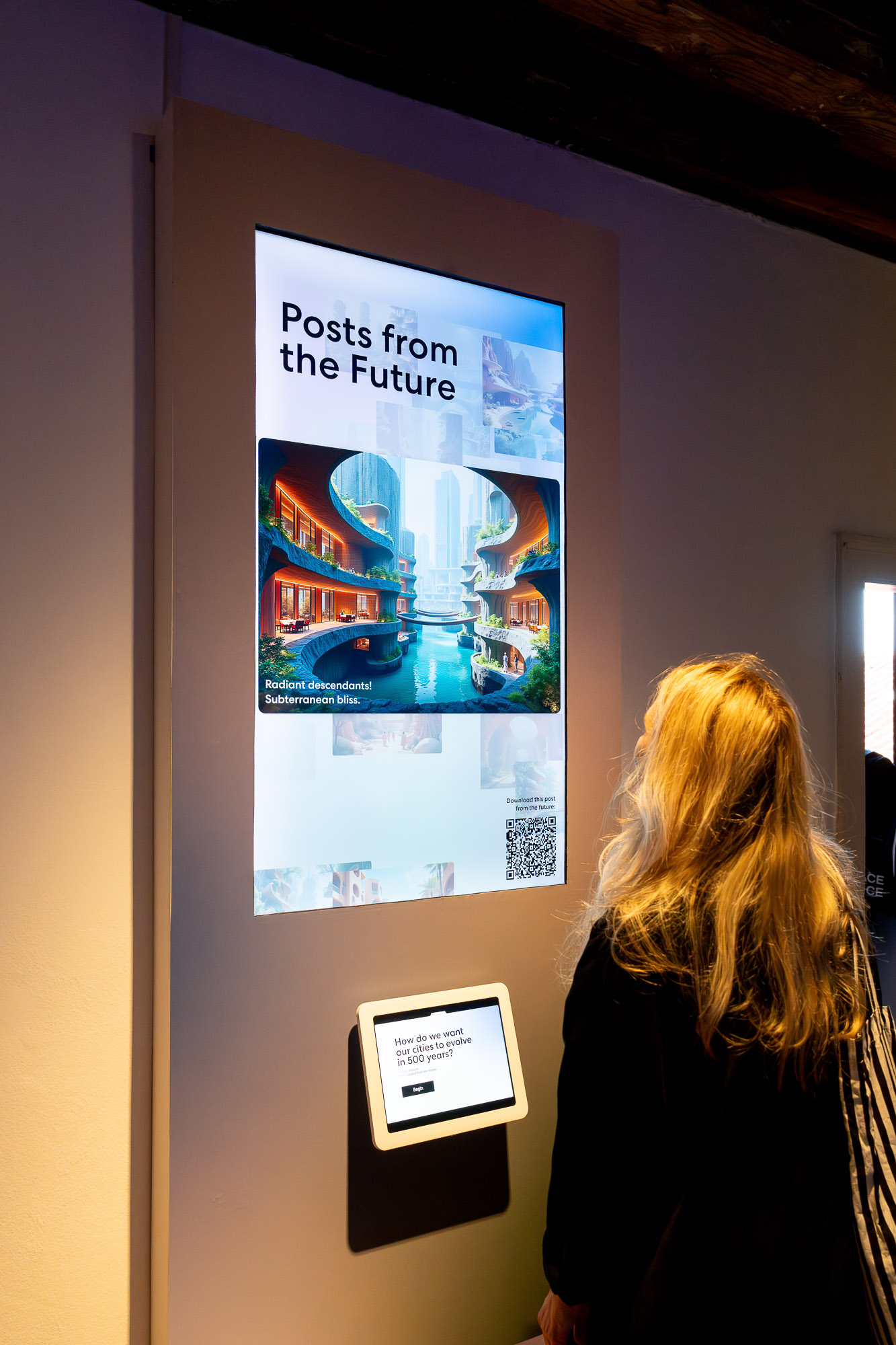 A woman looking at a poster on a wall.