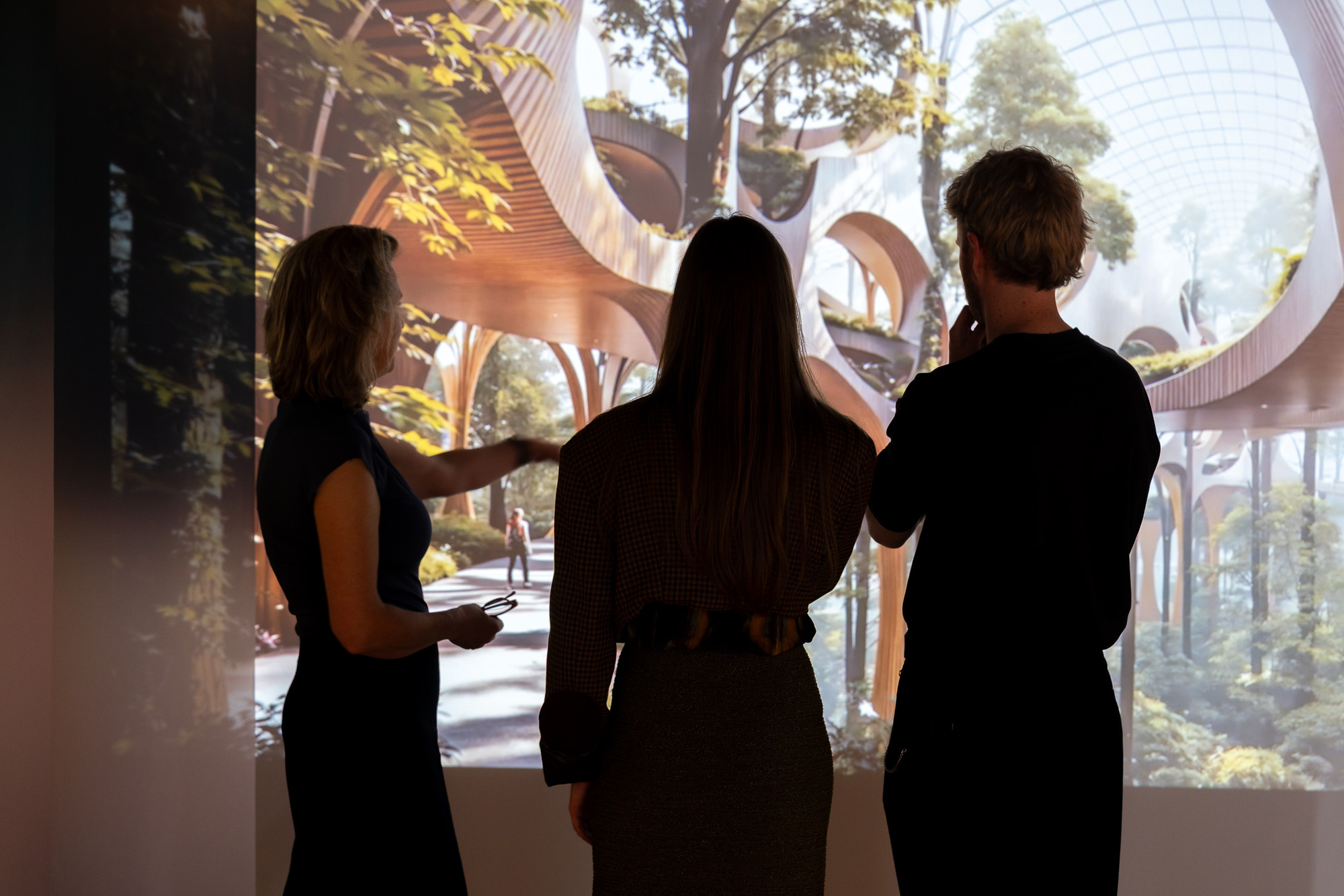 A group of people looking at a painting.