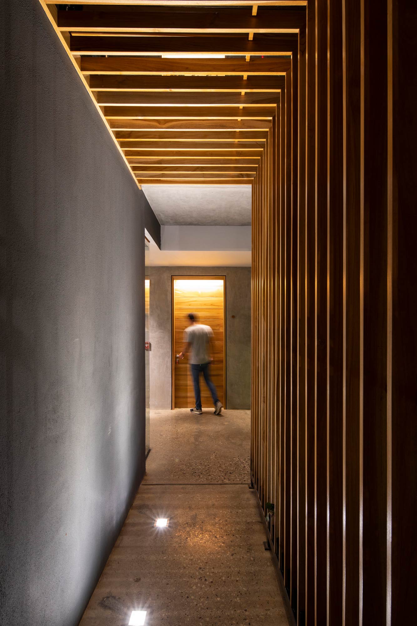 A person walking down a hallway.
