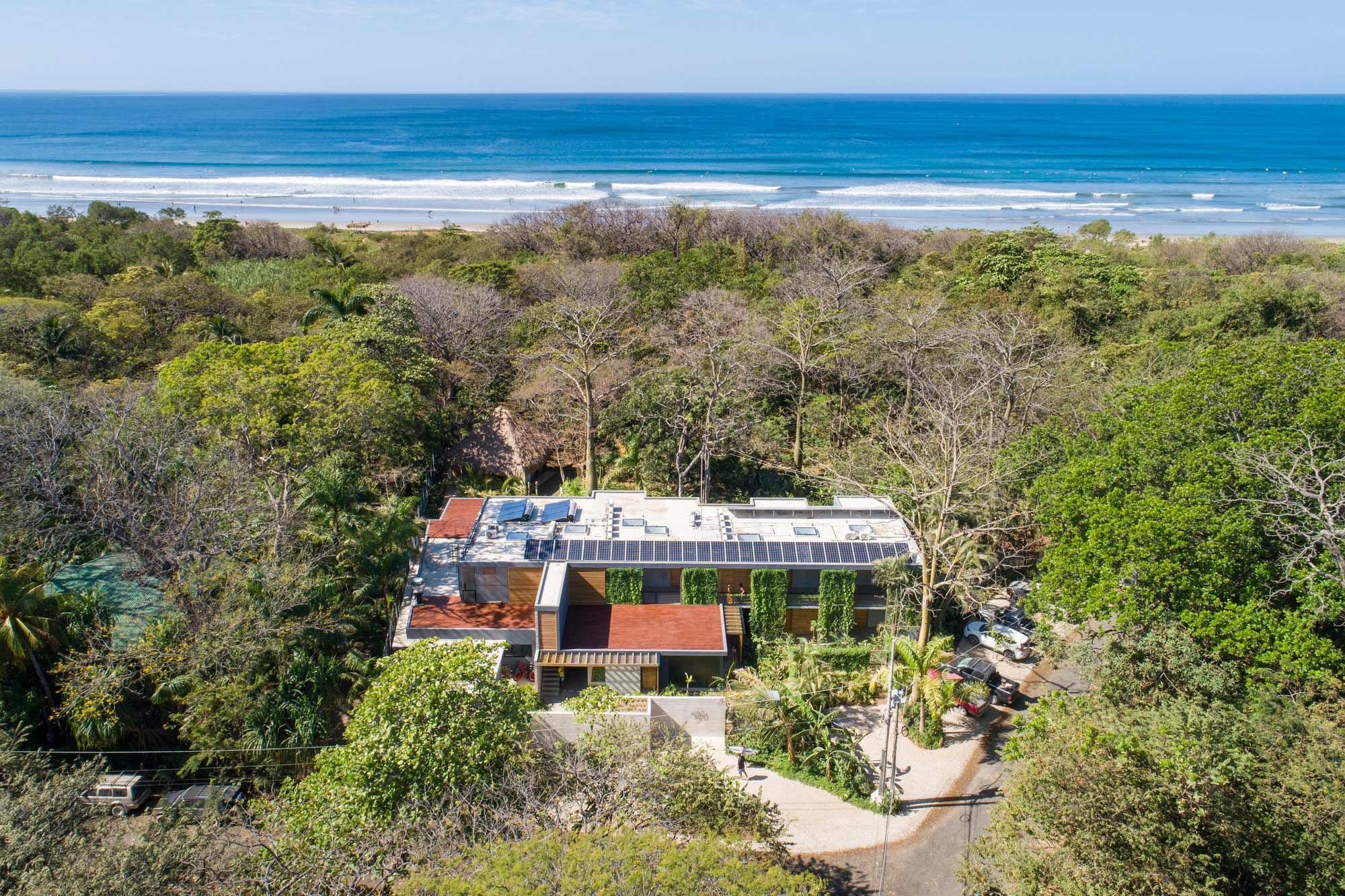 A house surrounded by trees and water.