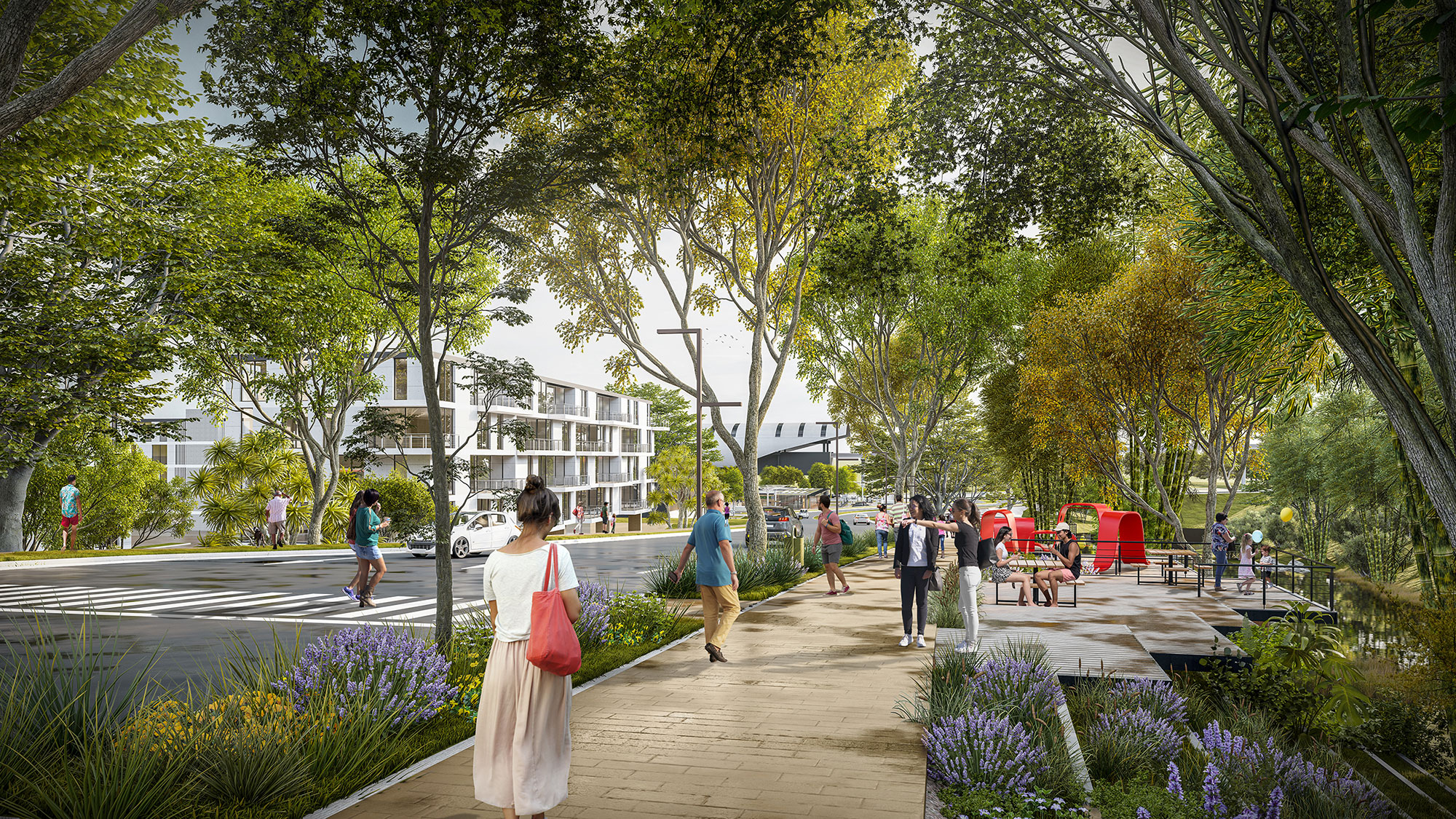 People walking on a path in a park with trees and buildings.