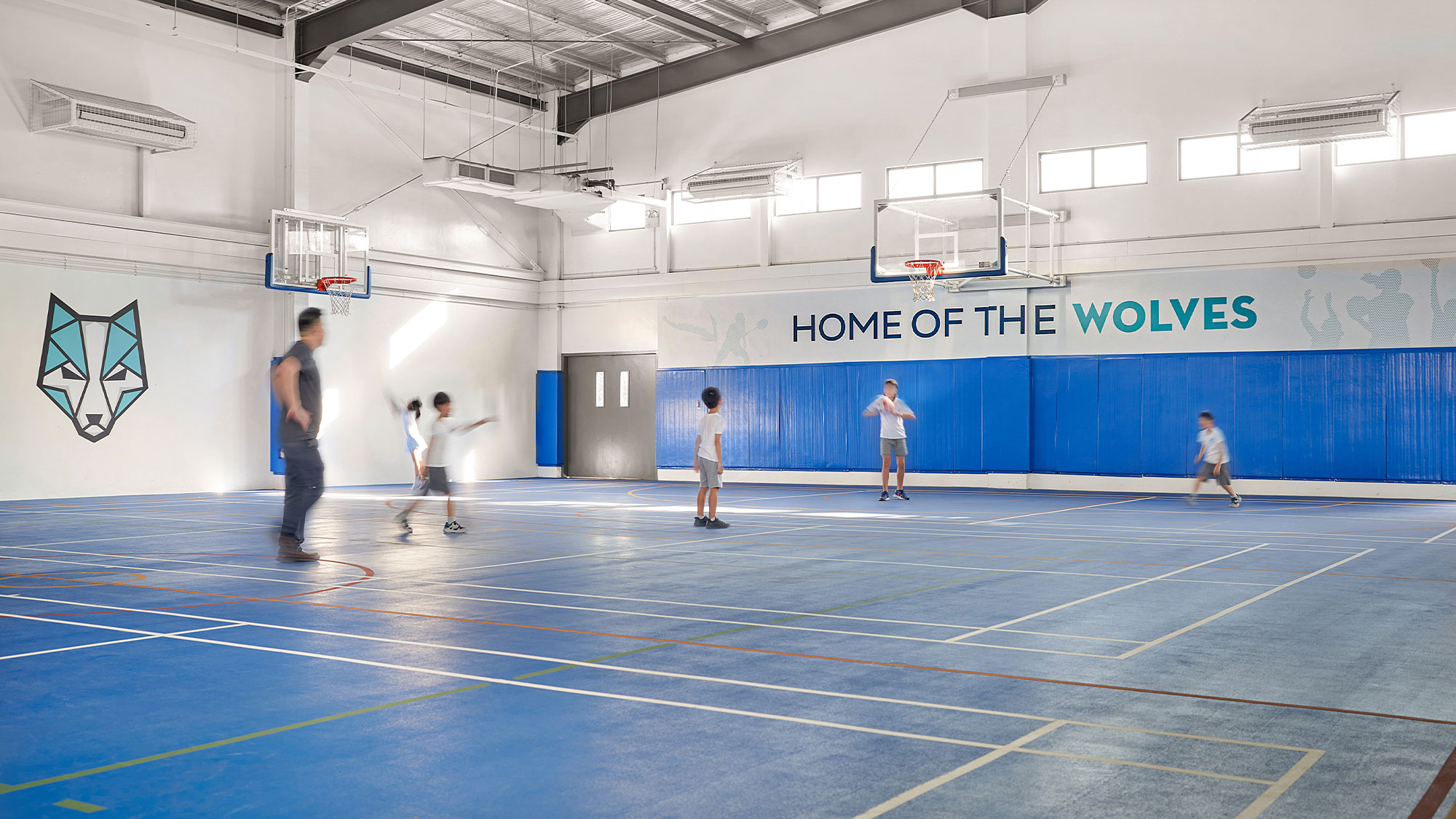 A group of people playing basketball.