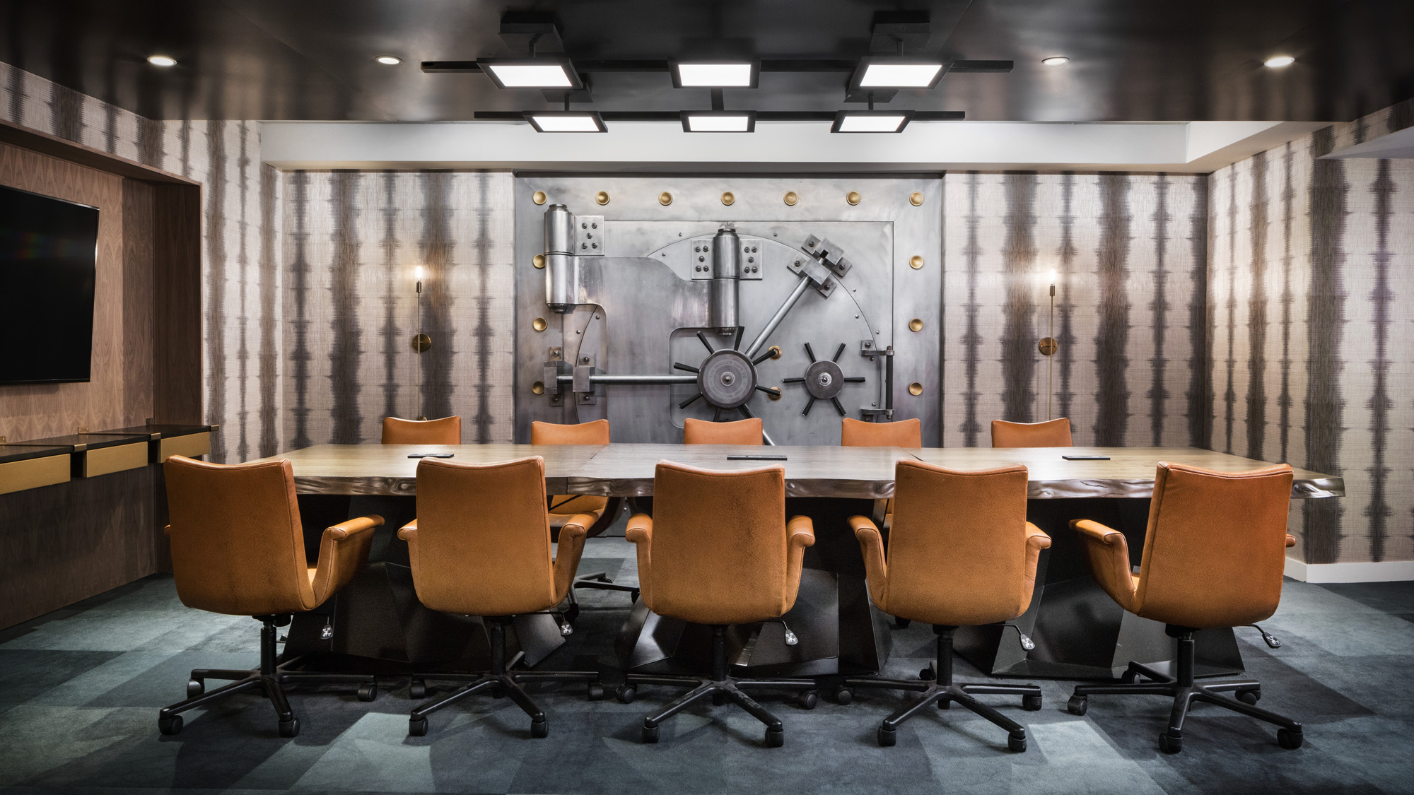 A conference room with a large table and chairs.