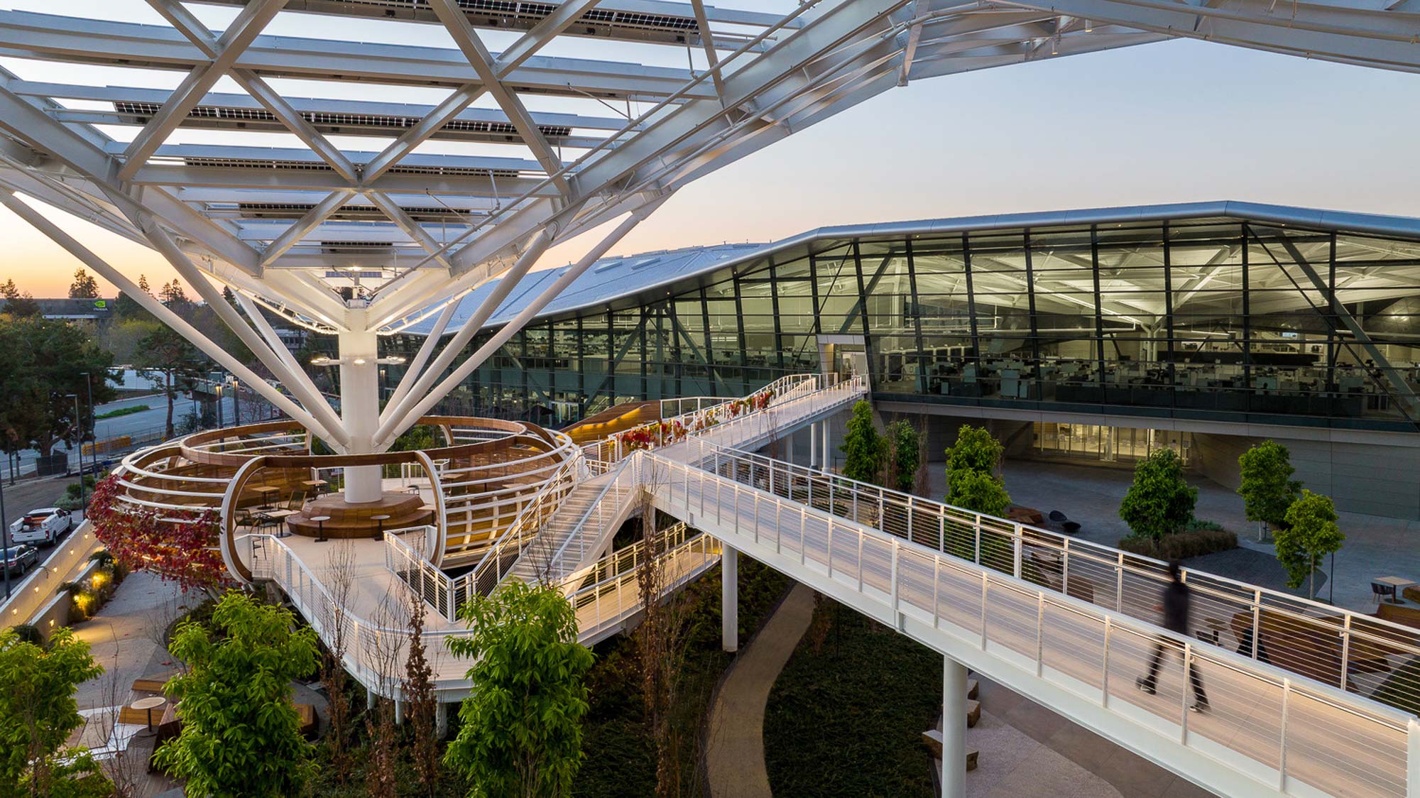 A large glass building with a walkway.
