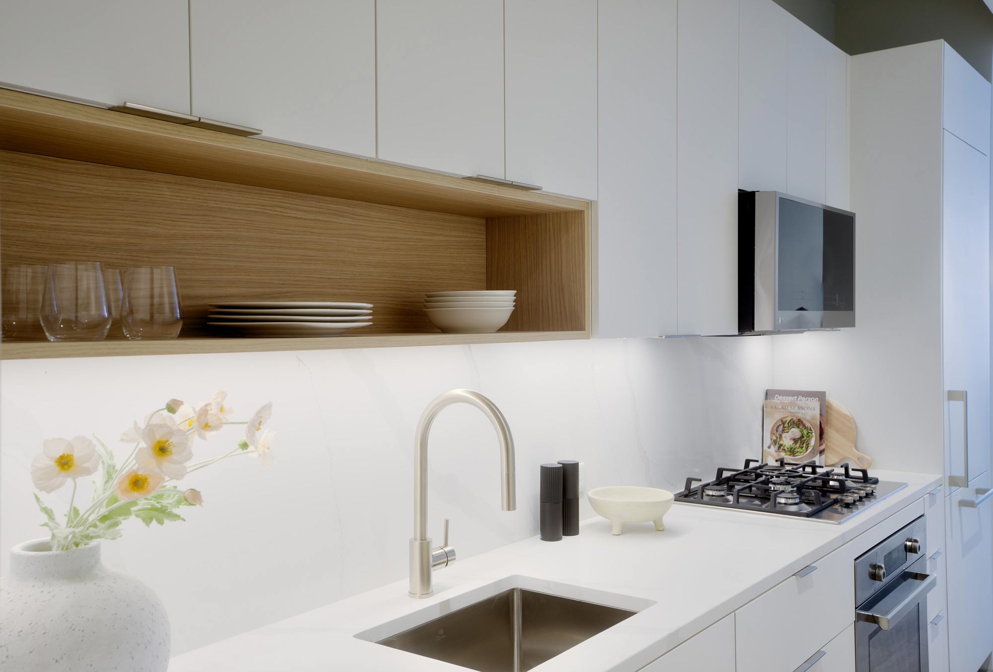 A kitchen with white cabinets.