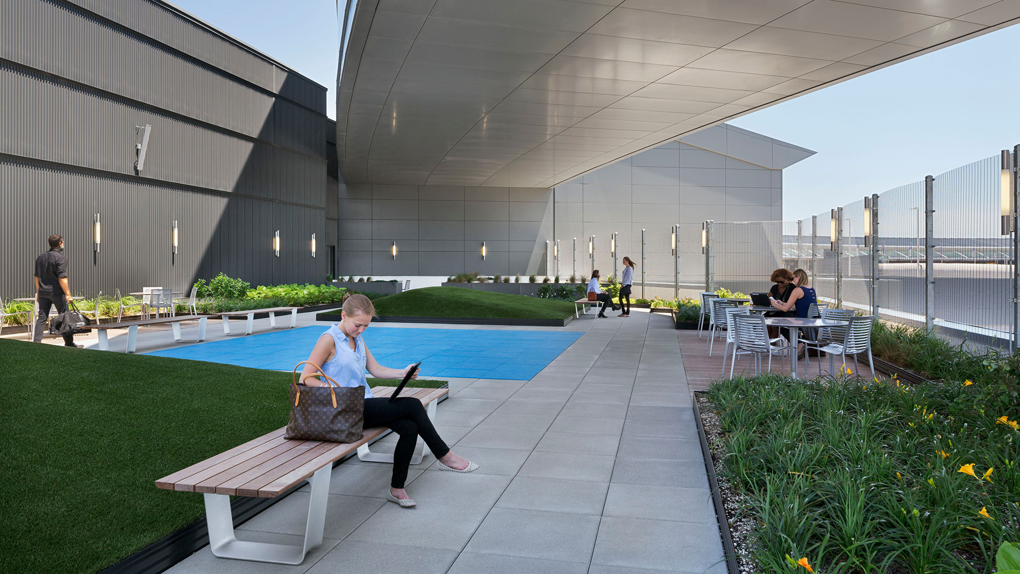 A person sitting on a bench next to a pool.