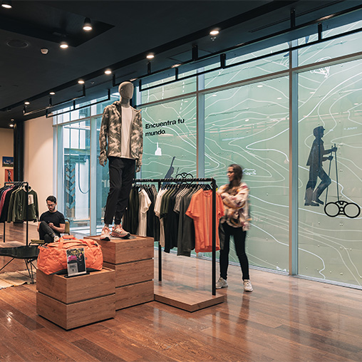 A man and woman in a clothing store.