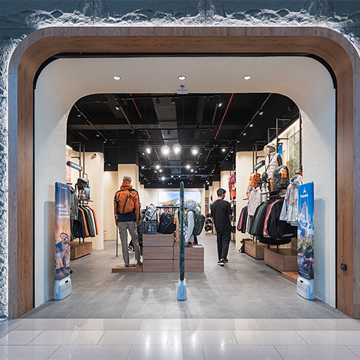 A couple of men walking through a store.