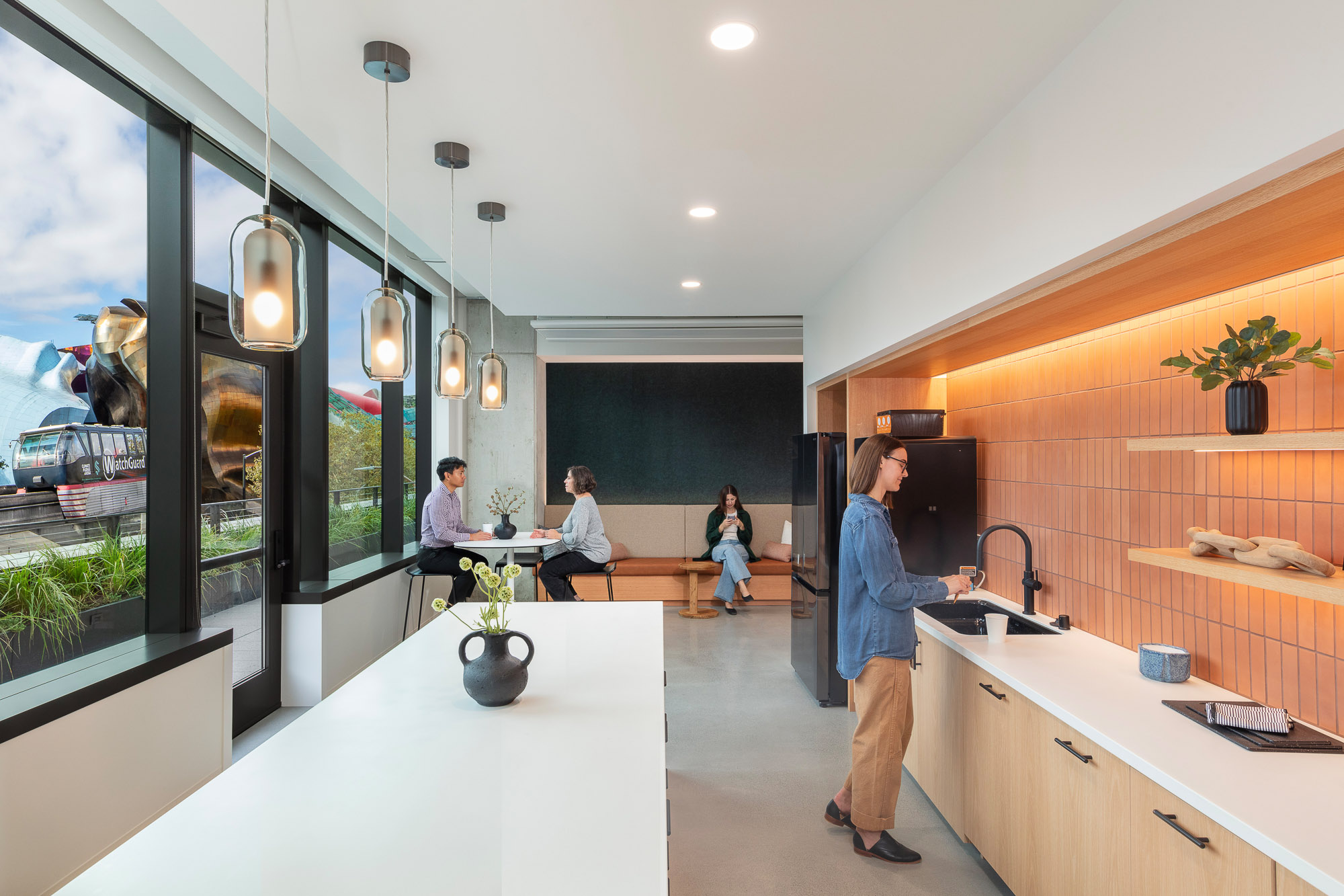 A group of people in a kitchen.