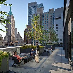 A group of people sitting on the rooftop of Gensler’s Pearl House, a residential building converted from an office.